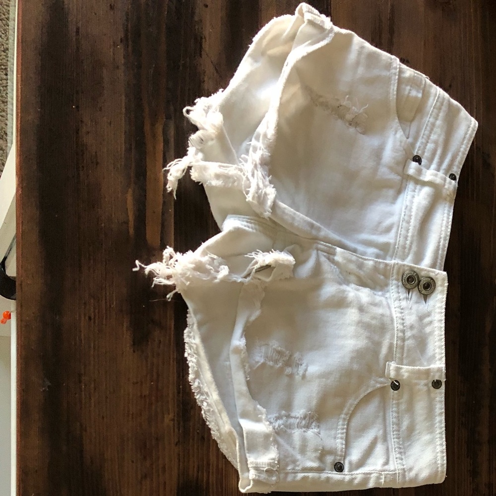 Distressed white jean shorts